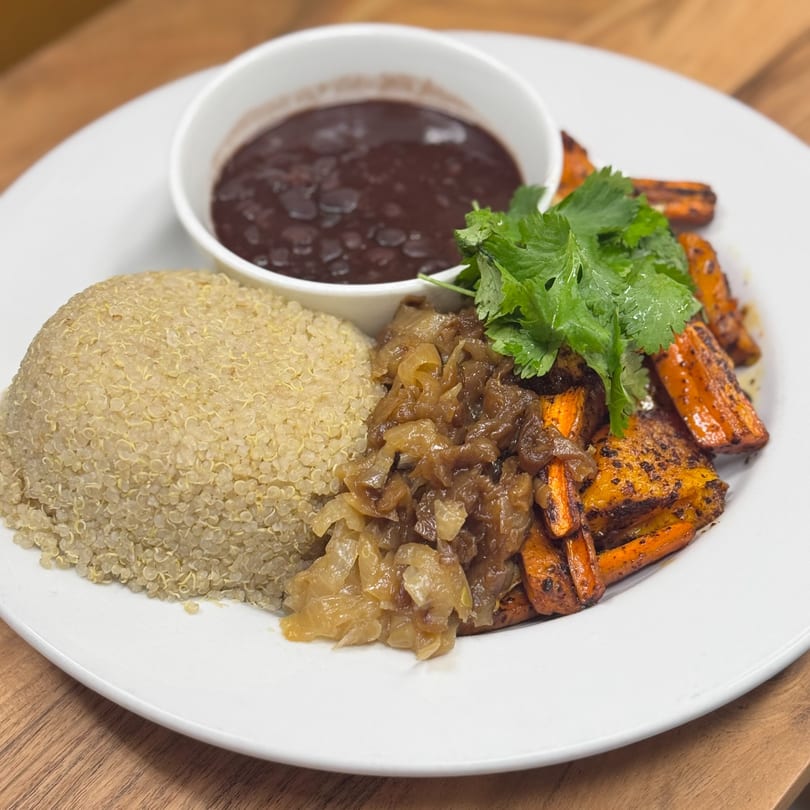 hOmkitchen's healthy meal with quinoa, roasted carrots, caramelized onions, and black bean soup.